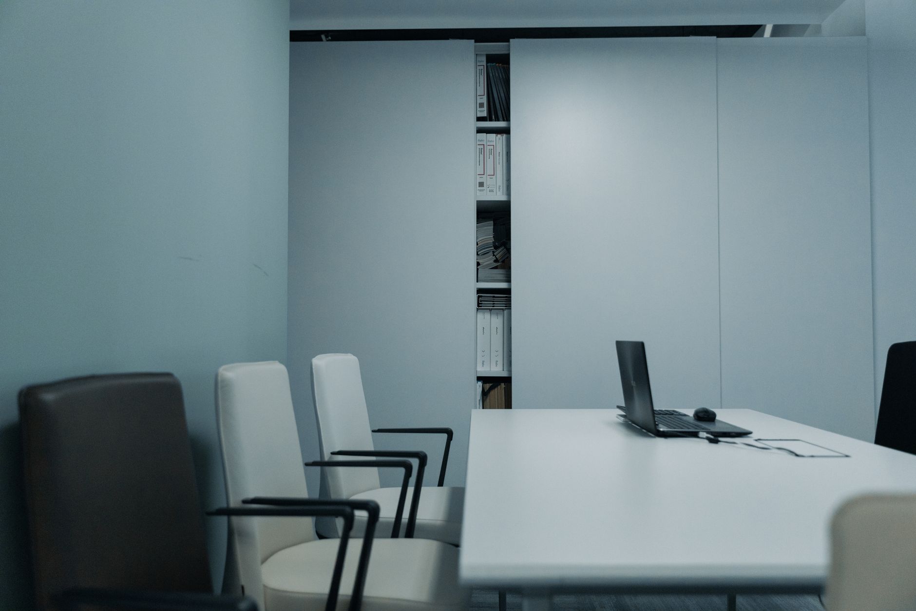 A meeting room with shelves of law books