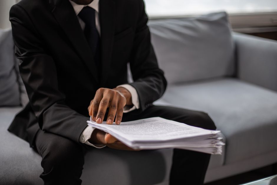 A lawyer in a suit reviewing documents at a table